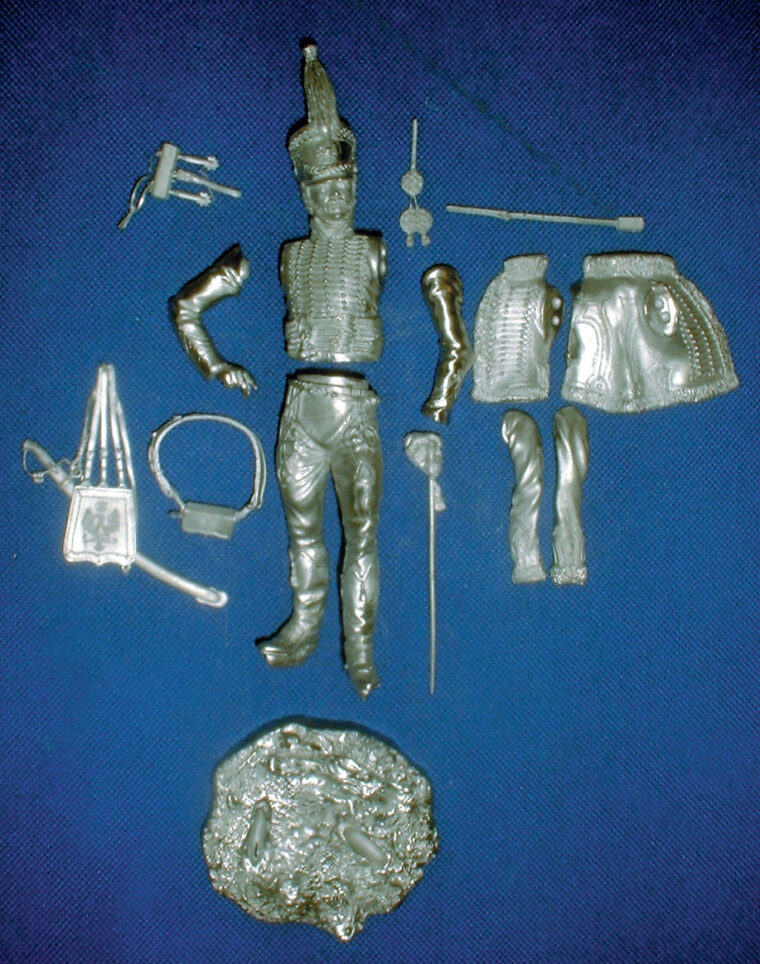 Parts from a kit as they come from the box. Military miniatures have grown to include models of armor and aircraft that are displayed with their crews, pilots, or ground crews.