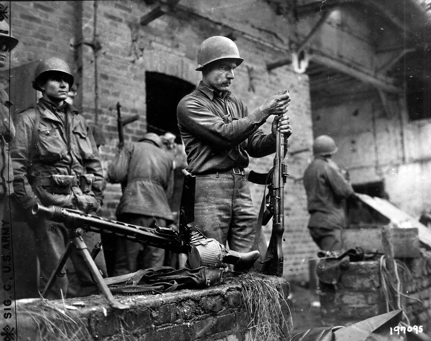 Private Henry Higgan of the 84th Infantry Division cleans a German Sturmgewehr 44 assault rifle captured during the fighting at Suggarath. The Sturmgewehr brought tremendous firepower to the squad level in the hands of a single German soldier and was considered a formidable weapon in the last days of World War II.