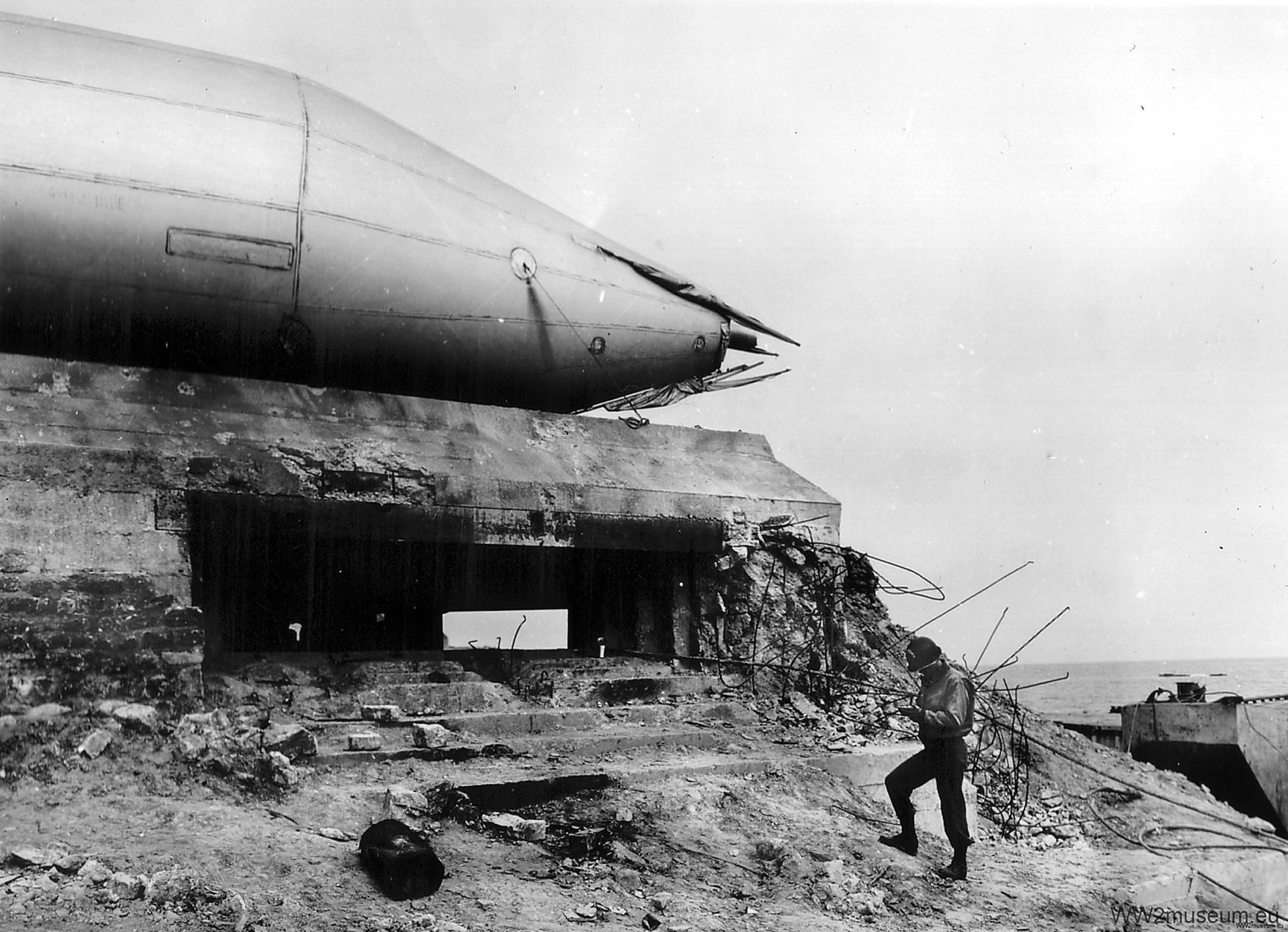 Awaiting disposition amid the air defenses at Omaha Beach, a barrage balloon sits atop the former German defensive position WN (Widerstandsnest—“resistance nest”) 72. At lower right an American engineer makes notes regarding his surroundings.