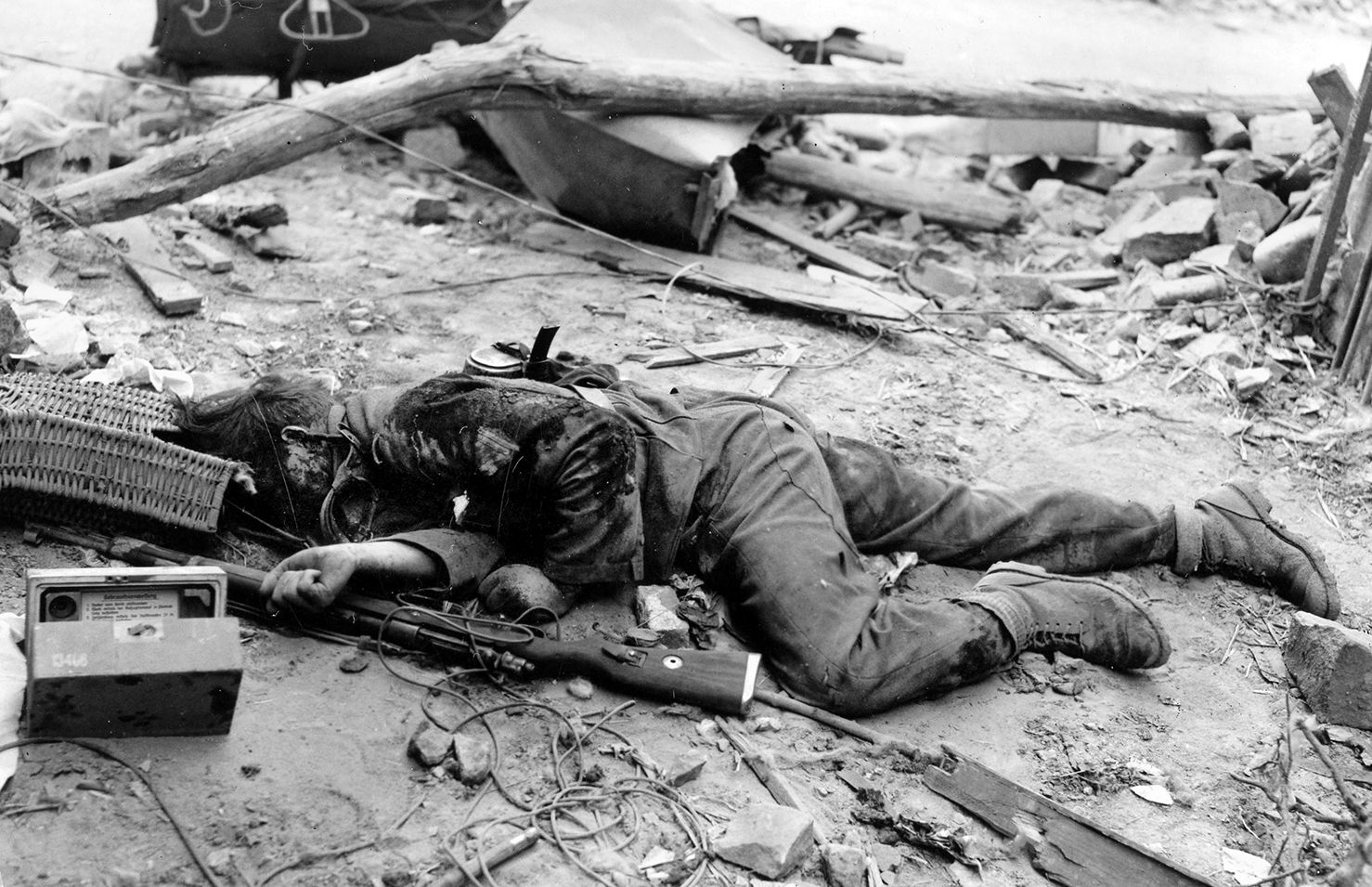 A dead German soldier sprawled on the street of an unidentified German city. Describing the first dead body he ever saw, a young German lying by the side of the road, Private First Class Bob Wolf recalled that even “his hair looked dead.”