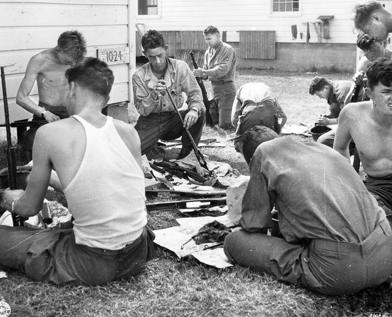 Veterans of the 86th clean and oil their rifles at Camp Gruber, Oklahoma, after they completed retraining on their weapons. They would soon ship out to the Pacific Theater, even though the war had ended. 