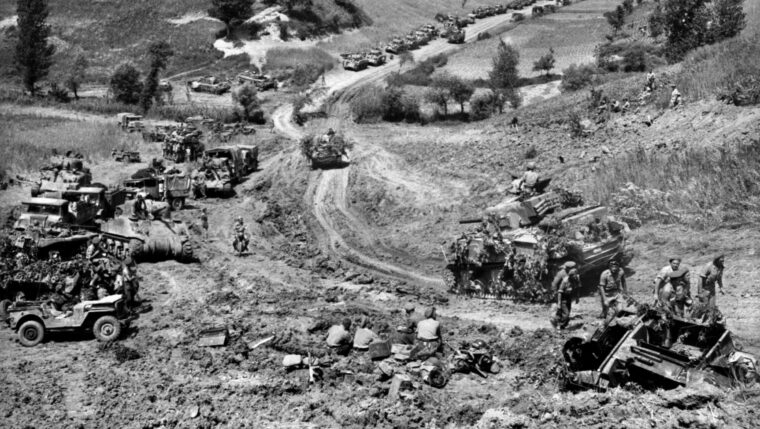 Canadian tanks and troops advance across the Liri Valley toward the so-called Hitler Line in May 1944. The tanks seen in the distance likely belong to the 8th “Princess Louise” Hussars, which accompanied the Cape Breton Highlanders during this movement forward in the Italian campaign.