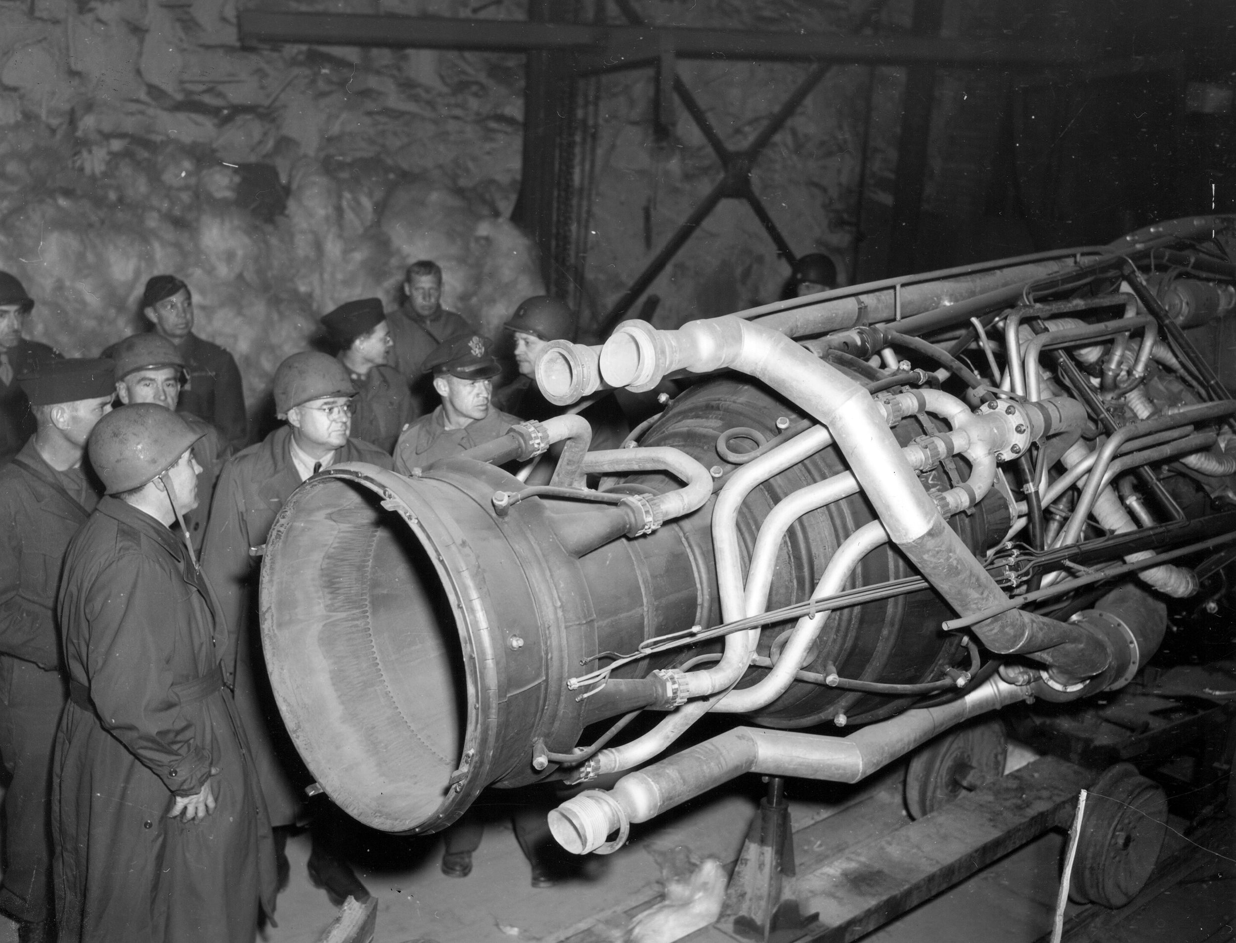 Members of a U.S. Congressional committee investigating German atrocities and war crimes inspect a rocket engine captured at an underground Nazi manufacturing facility at Nordhausen. A top American priority, Operation Paperclip was tasked with gathering German scientists and rocket technology for development in the U.S. after World War II.