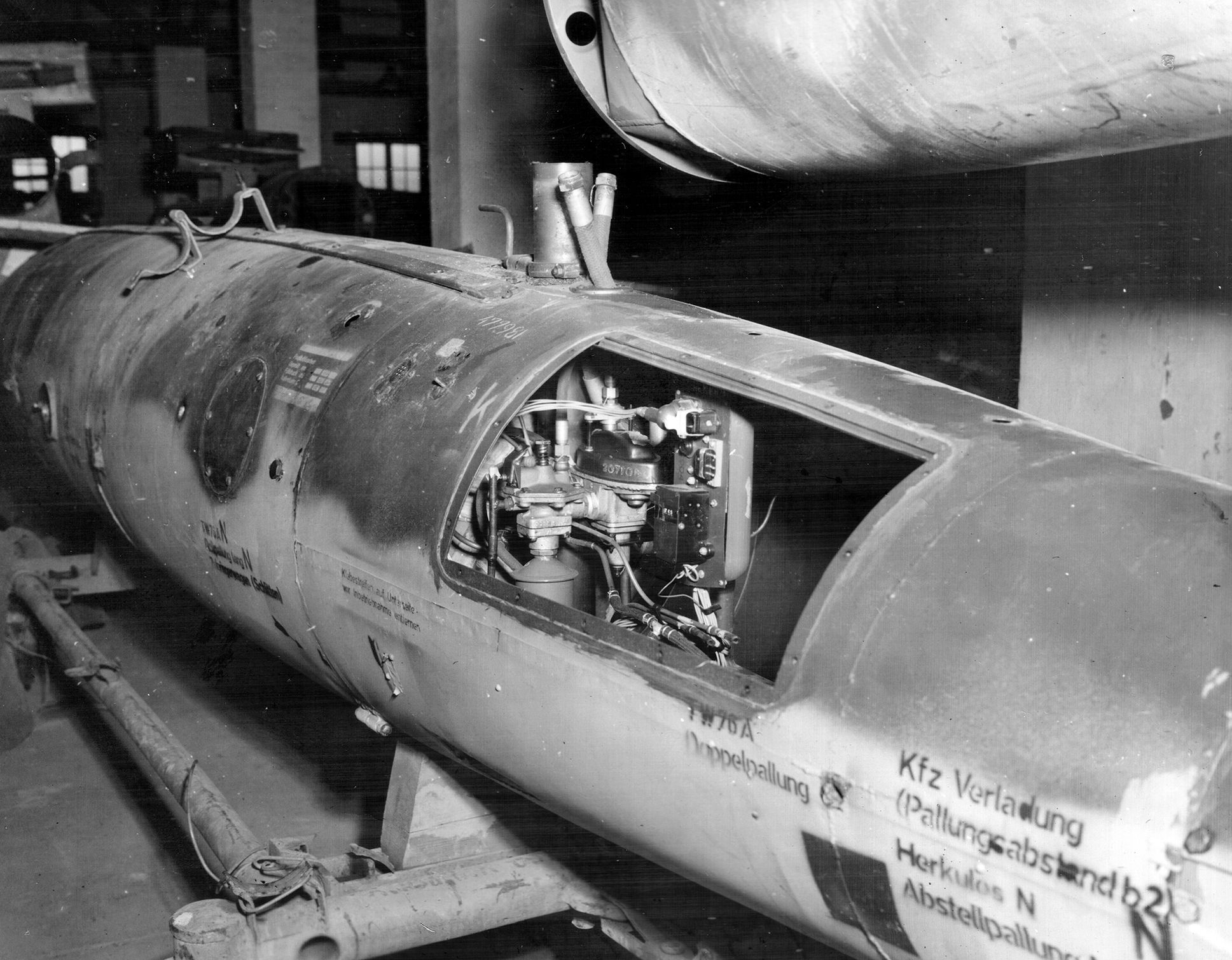 A captured V-1 Buzz Bomb is shown at the assembly plant at Nordhausen. The complex was sprawling, encompassing some three square miles with 85 buildings and camouflaged roads. U.S. personnel were in a race against time to bring Nazi rocket technology to the United States during Operation Paperclip.