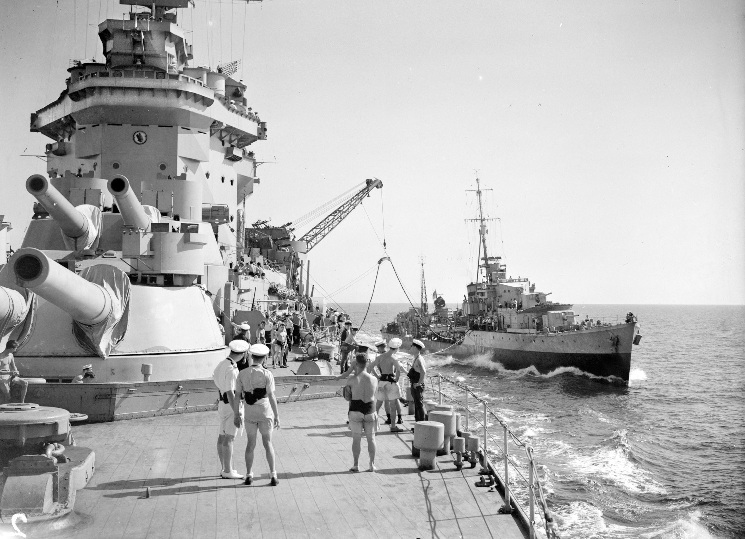Armament on display: HMS Warspite, with her 15-inch guns in the forward position, sails from Gibralter through the Mediterranean enroute to take part in support of Operation Husky, the Allied invasion of Sicily, July 1943. By the time she was decommissioned, Warspite had earned the most battle honors ever awarded to an individual ship in the Royal Navy and the most awarded for actions during World War II.