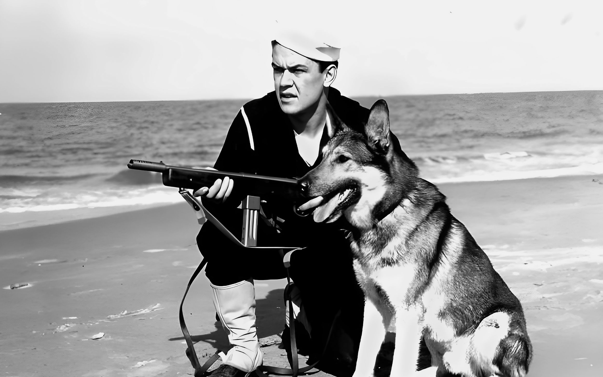 A U.S. Coast Guardsman carries a Model 50 Reising submachine gun while on patrol with his dog. The Reising proved to be quite unpopular with line troops fighting during World War II, particularly Marine units in tropical climates.