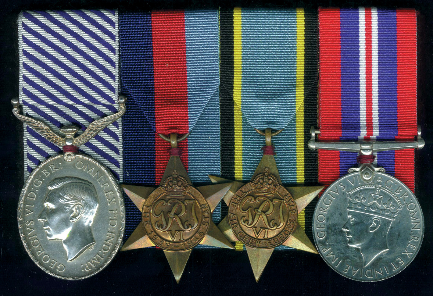 An RAF Medal group including, from left to right, the Distinguished Flying Medal, 1939-45 Star, Air Crew Europe Star, and War Medal awarded to an RAF radioman who served with Bomber Command 1943-45.