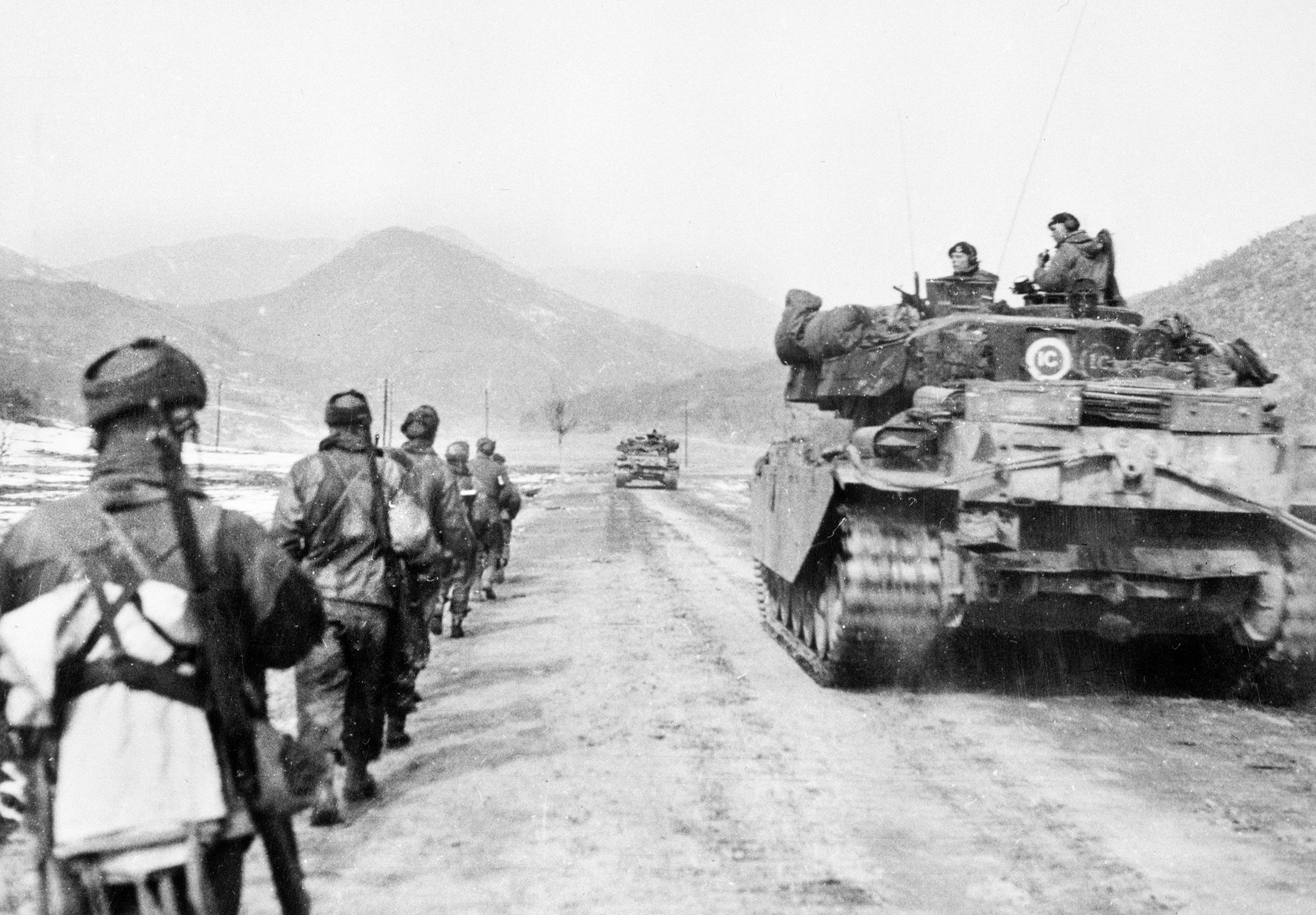 Infantrymen and tanks from the Gloucestershire Regiment advance to attack Hill 327 in Korea in March 1951. These Centurions, the main post-WWII battle tank for the British Army, made their combat debut in the Korean War in December 1950.