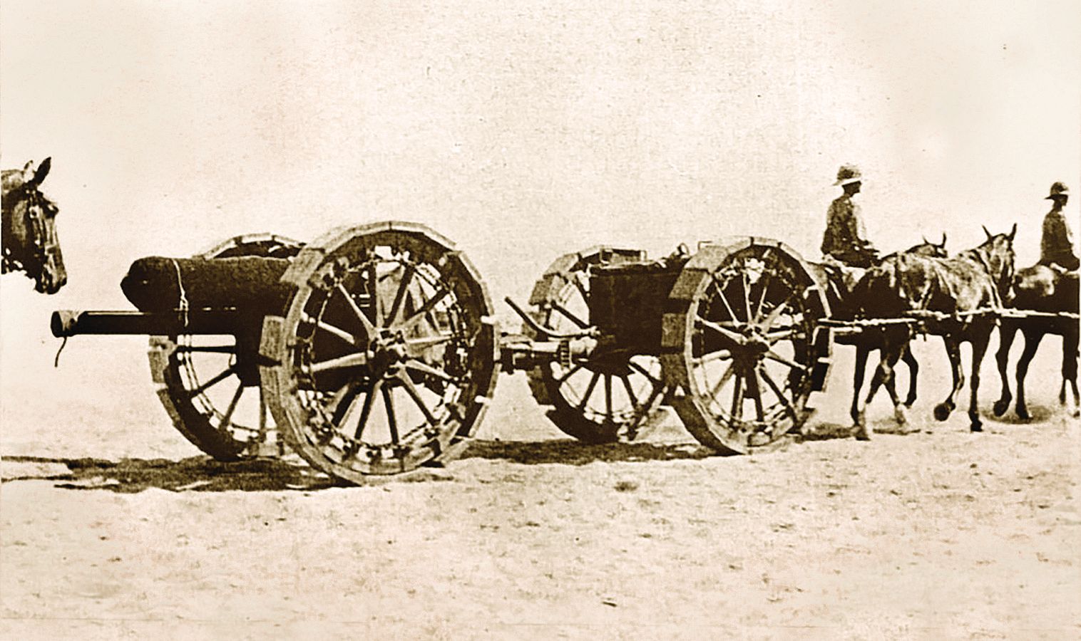 In the mud of France or the sands of Egypt, moving artillery is difficult work. Here a crew defending the Suez Canal pulls an 18-pound field gun fitted with “sand wheels” across the desert terrain in 1916. 