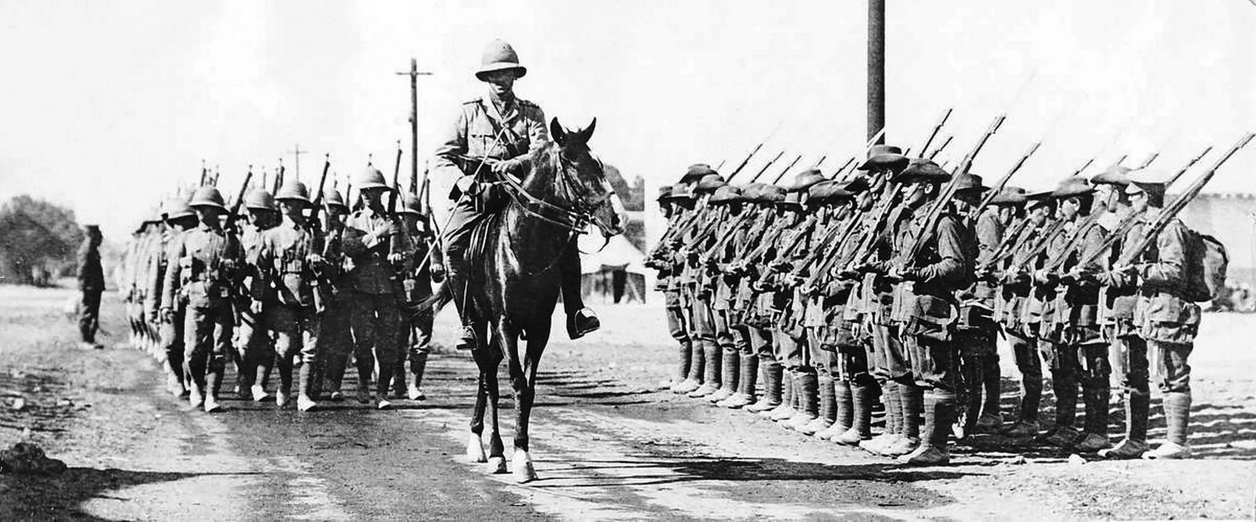 Led by their commanding officer on horseback, British troops from a Lancashire regiment  march to the front in Egypt. 