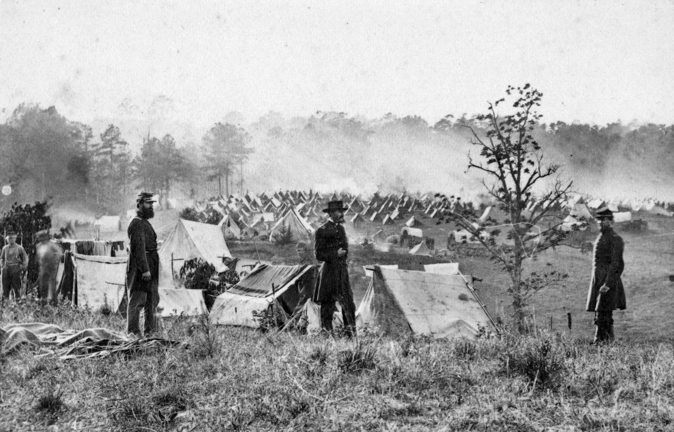 This Mathew Brady photograph shows unidentified soldiers in Union uniforms with tents in the background at the 66th New York Volunteers (French’s Brigade) camp at St. Peter's Church, Yorktown, Virginia.