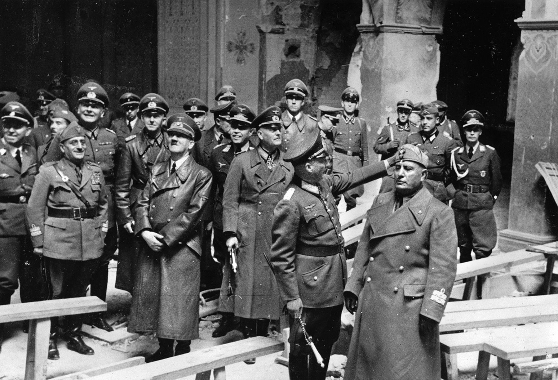 German Chancellor Adolf Hitler (front row, second from left) and Italian dictator Benito Mussolini (front row, far right) inspect the remains of Brest Fortress in Brest, Belarus, a month after it was taken in the first battle of Operation Barbarossa, the Axis invasion of the Soviet Union launched on June 22, 1941. 