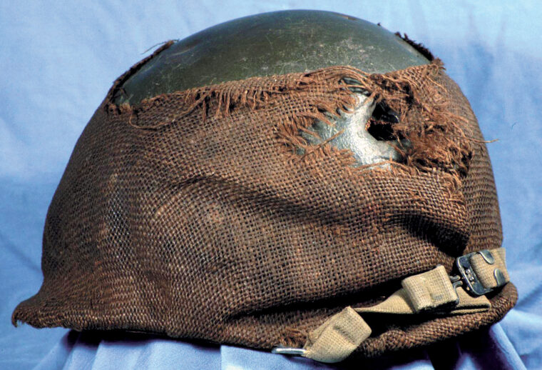  This burlap-covered M1 stopped a shell fragment. Its wearer was wounded, but the helmet saved his life.