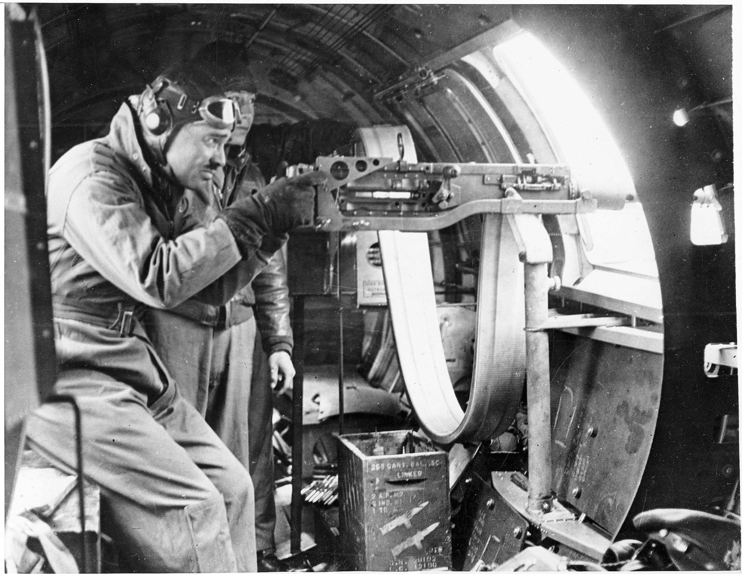 Aerial gunnery instructor Clark Gable demonstrates handling technics for waist gunners in England. 