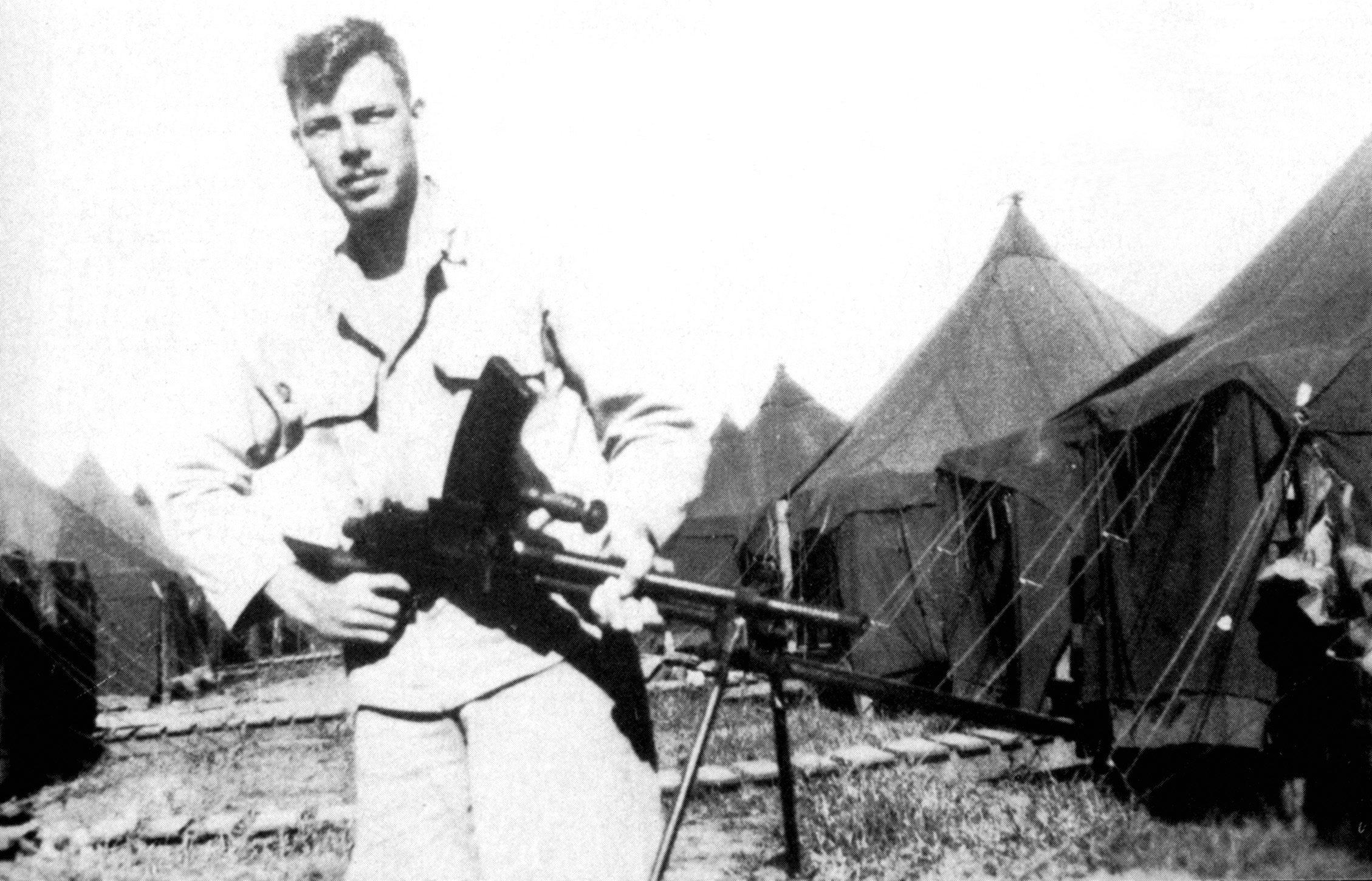 Private Lee Marvin farmiliarizes himself with a Japanese machine gun.