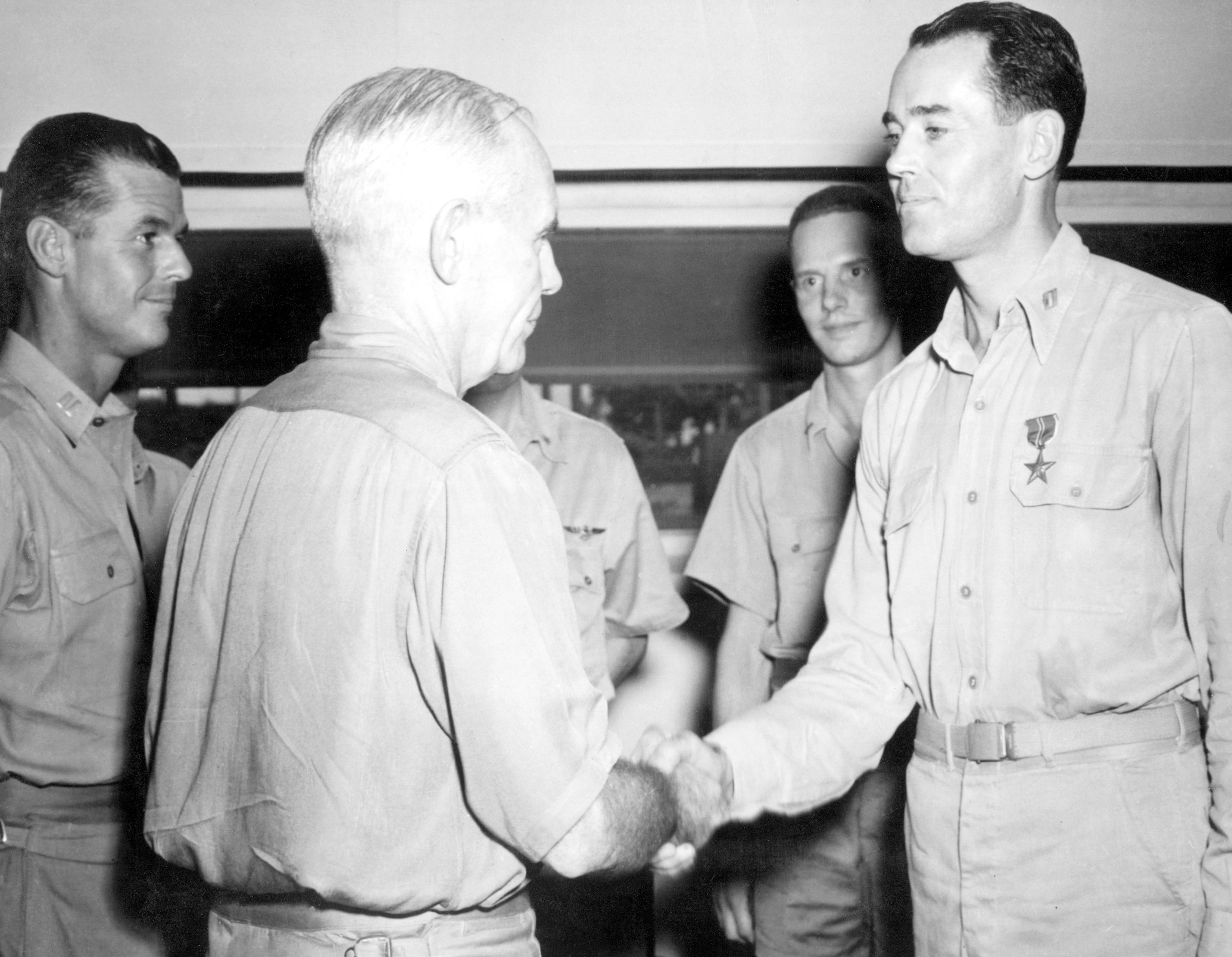 Captain Henry Fonda gets a Bronze Star and a handshake for his actions on the USS Curtis. 