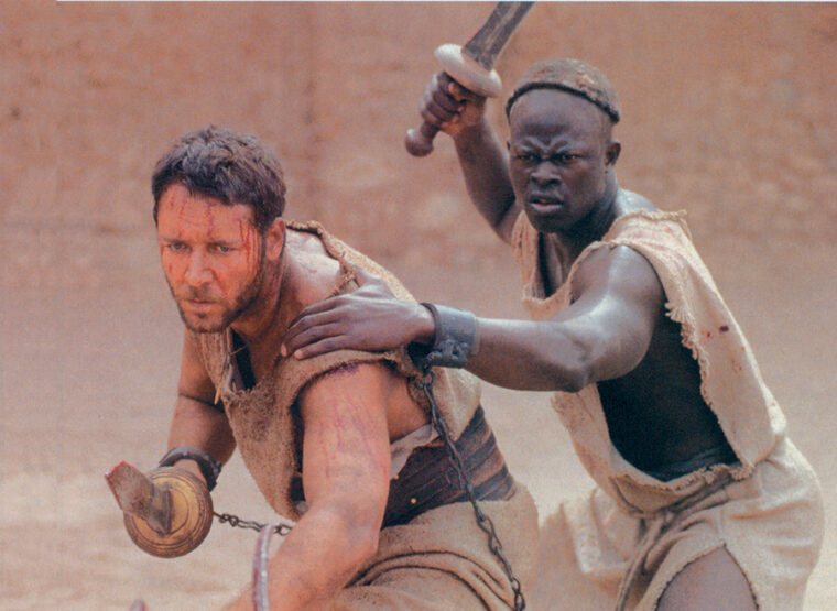 Gladiator movie actors get set for a fight. Russell Crowe at left is wielding a gladius.