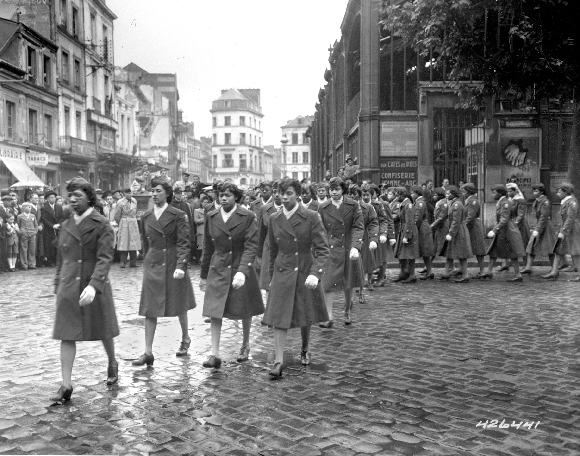 The women soldiers of the 6888th Central Postal Directory Battalion parade through the streets of Rouen, France. The women broke backlogs of mail in England and France during the end of the war in Europe.