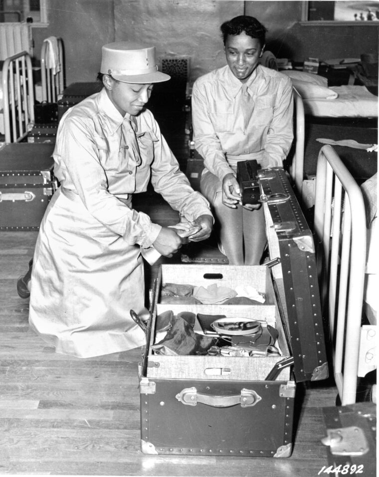 Two African-American Women’s Army Corps soldiers prepare for a locker box inspection at Fort Des Moines, Iowa.