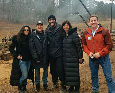 Kevin Hymel who wrote the article the movie was based on, served as a technical advisor on the set of The Six Triple Eight. Tyler Perry (center) wrote, produced, and directed the movie, Peter Guber (second from left) served as the executive producer, while Keri Selig (left) and Carlota Espinosa (right) served as producers on the film.