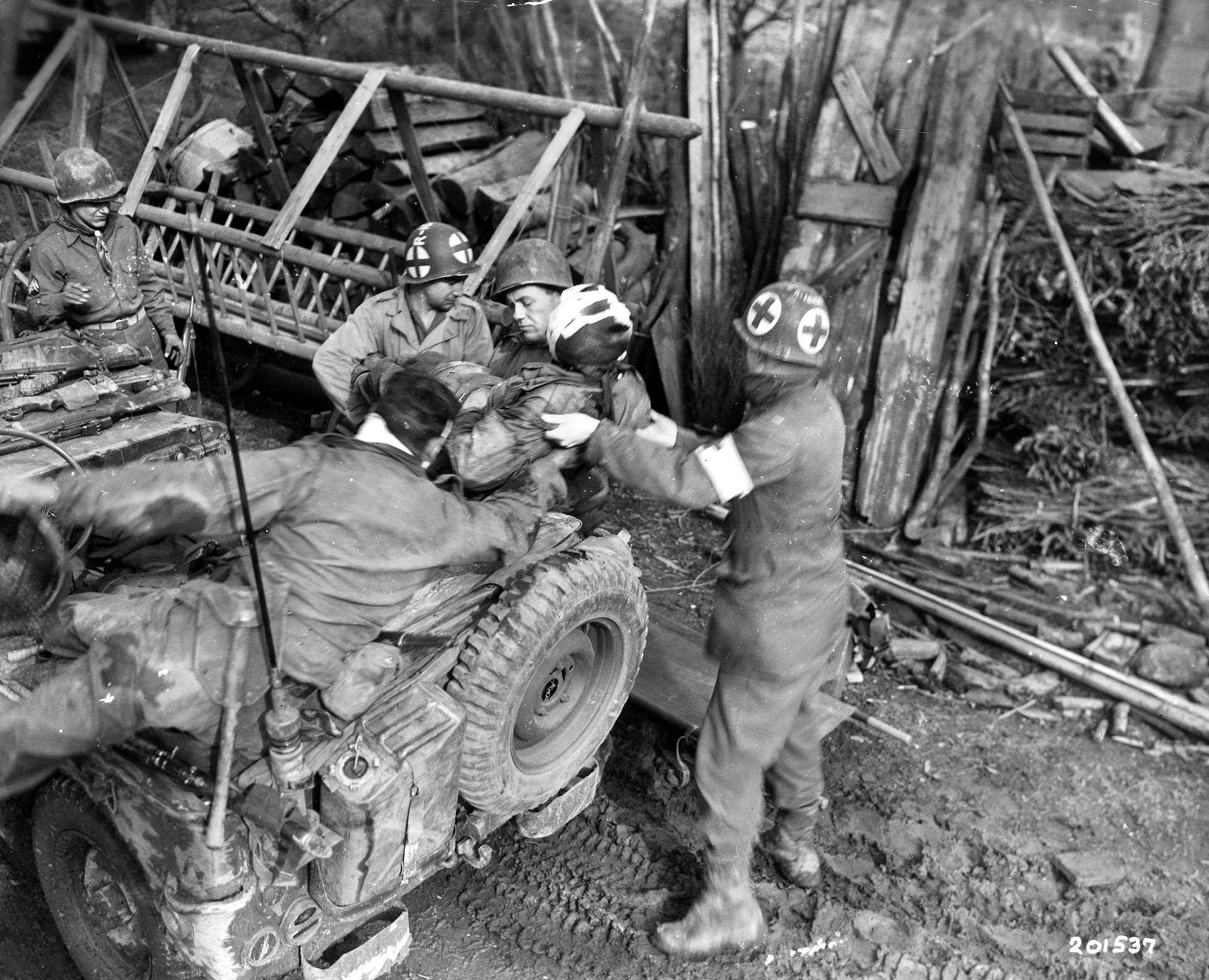 During winter fighting, medics gingerly load a seriously wounded soldier aboard a vehicle for evacuation from a frontline aid station. The aid stations were often packed with wounded men, and the lives of many in serious condition were saved due to the close proximity of the facilities to the battlefield. 