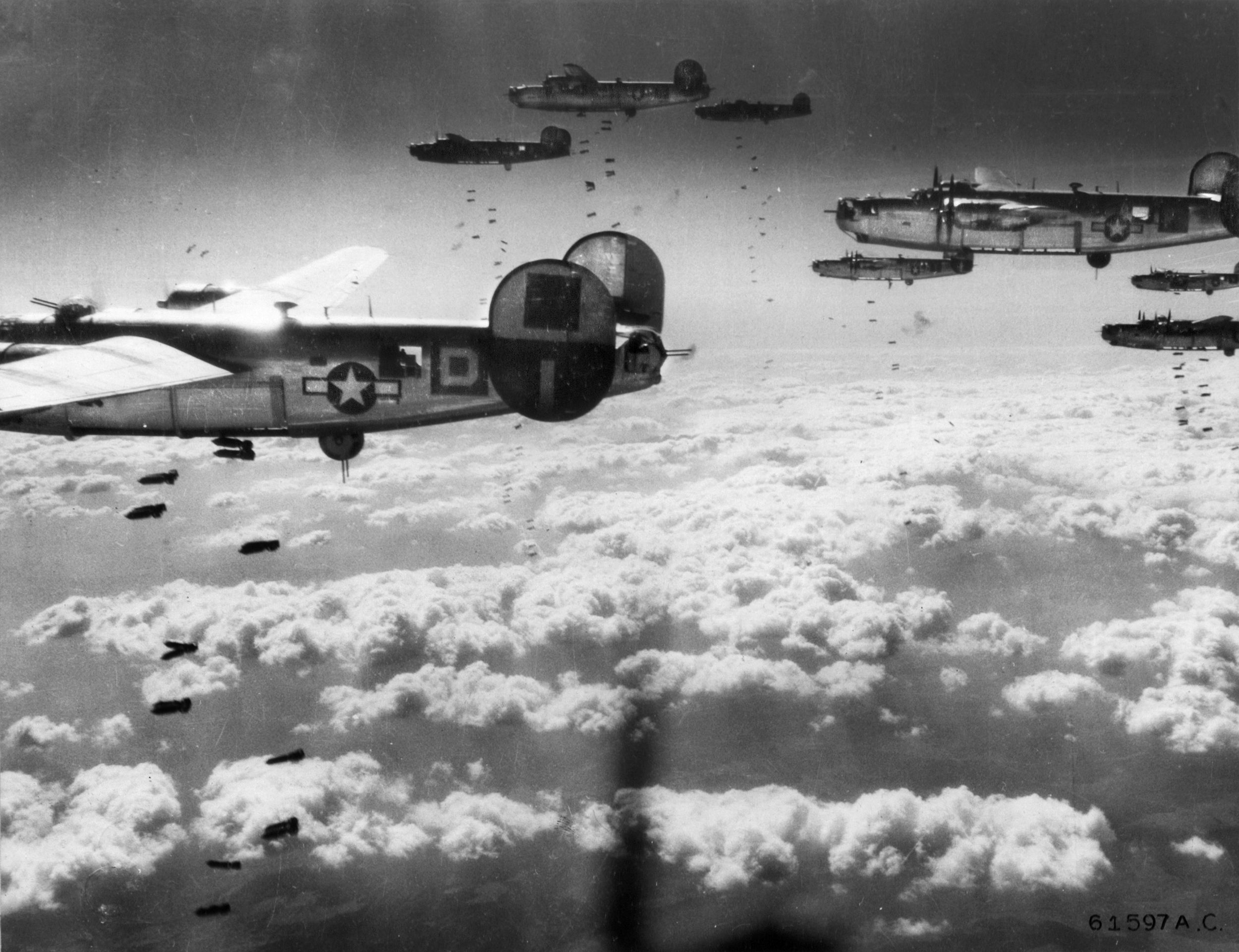 Flying in close formation to provide mutual defense against marauding German fighters, B-24 Liberator bombers of the Fifteenth Air Force drop their bombs on a target in Austria. During the April 2 raid on the Steyr ball-bearing factories, mission commander Lt. Col. Kenneth Cool stressed the importance of formation flying. As a result of Cool’s quick thinking and leadership, the 455th Bombardment Group received a Presidential Unit Citation for the mission. 