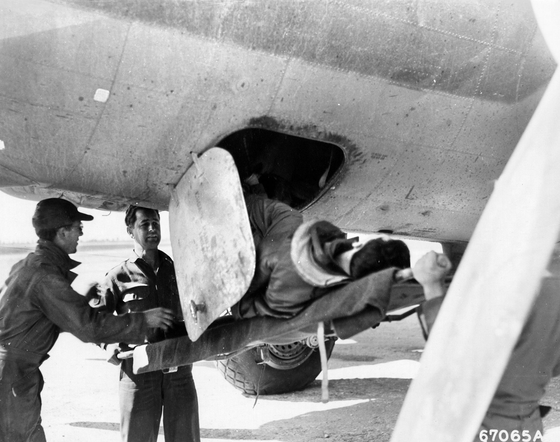 After the Steyr raid, a wounded crewman is gingerly removed from his damaged B-17 Flying Fortress bomber to be placed on a stretcher and taken to a waiting ambulance. The costly Steyr raid was indicative of the maximum effort Allied bomber crews put forth against enemy targets.