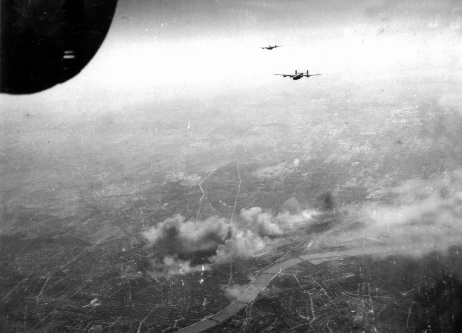 On April 3, 1944, the day after the Steyr raid, two B-24 Liberators of the 456th Bomb Group turn for home after attacking railroad marshalling yards in Budapest, Hungary. Allied Fifteenth Air Force bombers based in Italy conducted many raids against Axis targets in southern Germany, Italy, and other locations in Eastern Europe.