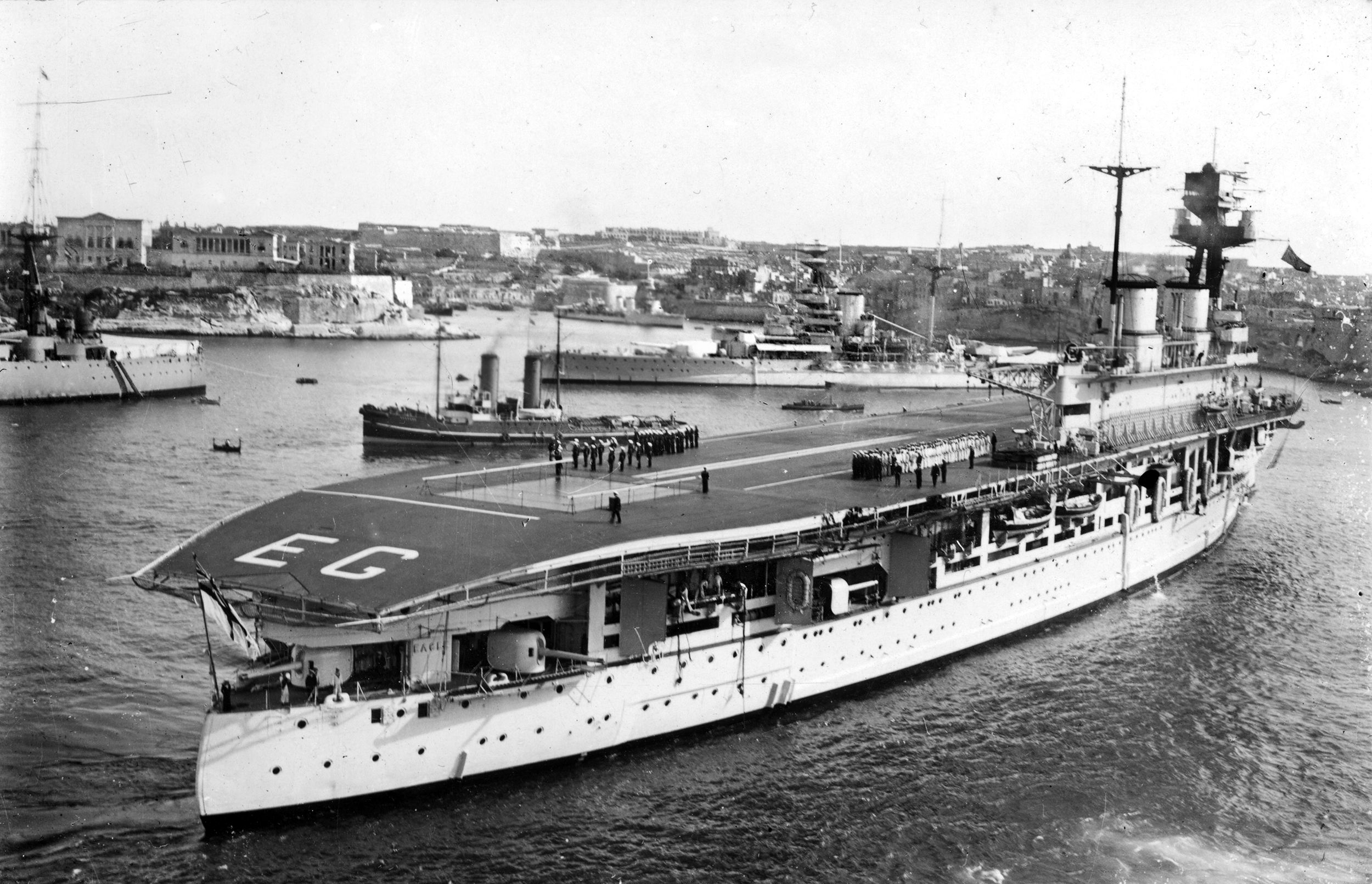 The aircraft carrier HMS Eagle is shown at Grand Harbor, Malta. A pre-World War I super dreadnought built for the Chilean Navy, Eagle was purchased by Great Britain and converted into an aircraft carrier. The carrier’s crew served heroically until Eagle was sunk by the German submarine U-73 in 1942.