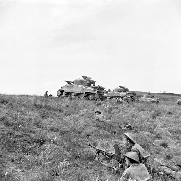 M4 Sherman medium tanks move into supporting positions with the infantrymen of the 2nd Battalion, 5th Regiment, 46th Division near Coldazzo. The infantry and armor hit the German and Italian defenders of the Gothic Line on August 30, 1944.