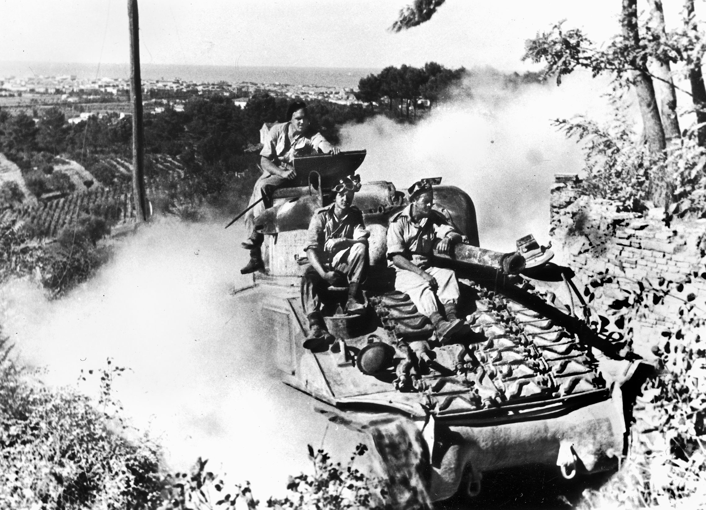 After breaking through the German defenses along the Gothic Line at the Italian town of Pesaro, infantrymen of the II Polish Corps ride atop the Sherman tanks of the Polish 1st Krechowiecki Uhlan Regiment. The Gothic Line was the last major German defensive barrier in northern Italy, and the fighting along its Adriatic sector was vicious.