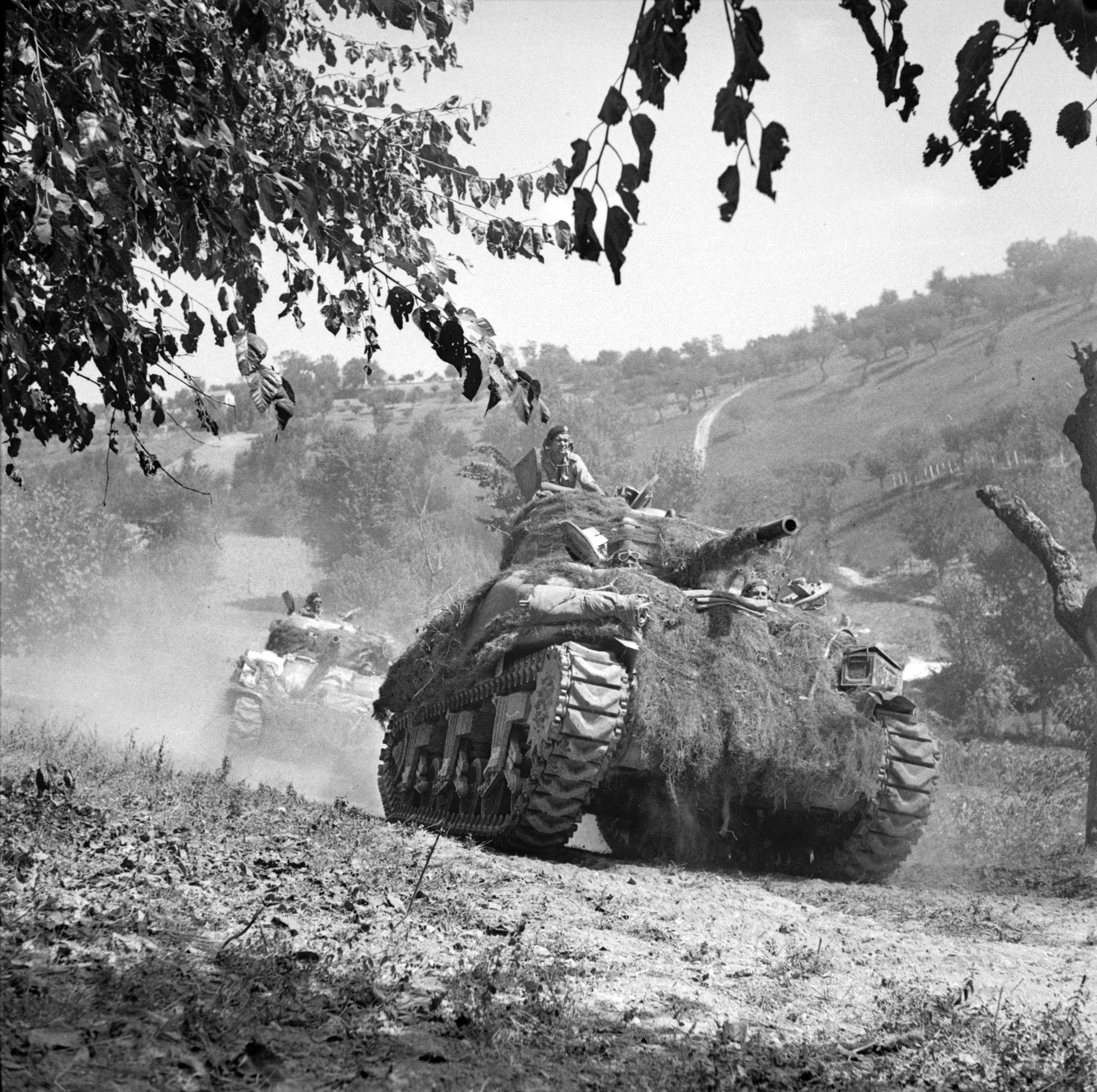 M4 Sherman medium tanks of the 1st Canadian Armoured Division stir up clouds of dust as they rumble forward during the advance toward the Germans’ Gothic Line defenses in August 1944. Although the Gothic Line was breached, the German Tenth Army remained a potent fighting force.