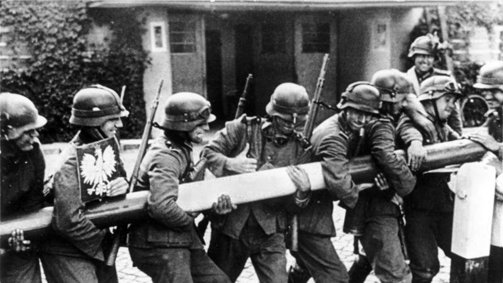 German soldiers remove the gate at a checkpoint in a street in the city of Danzig, supposedly on September 1, 1939. However, under further scrutiny some analysts conclude that the photo was taken two weeks after the initial German invasion of Poland solely for propaganda purposes.