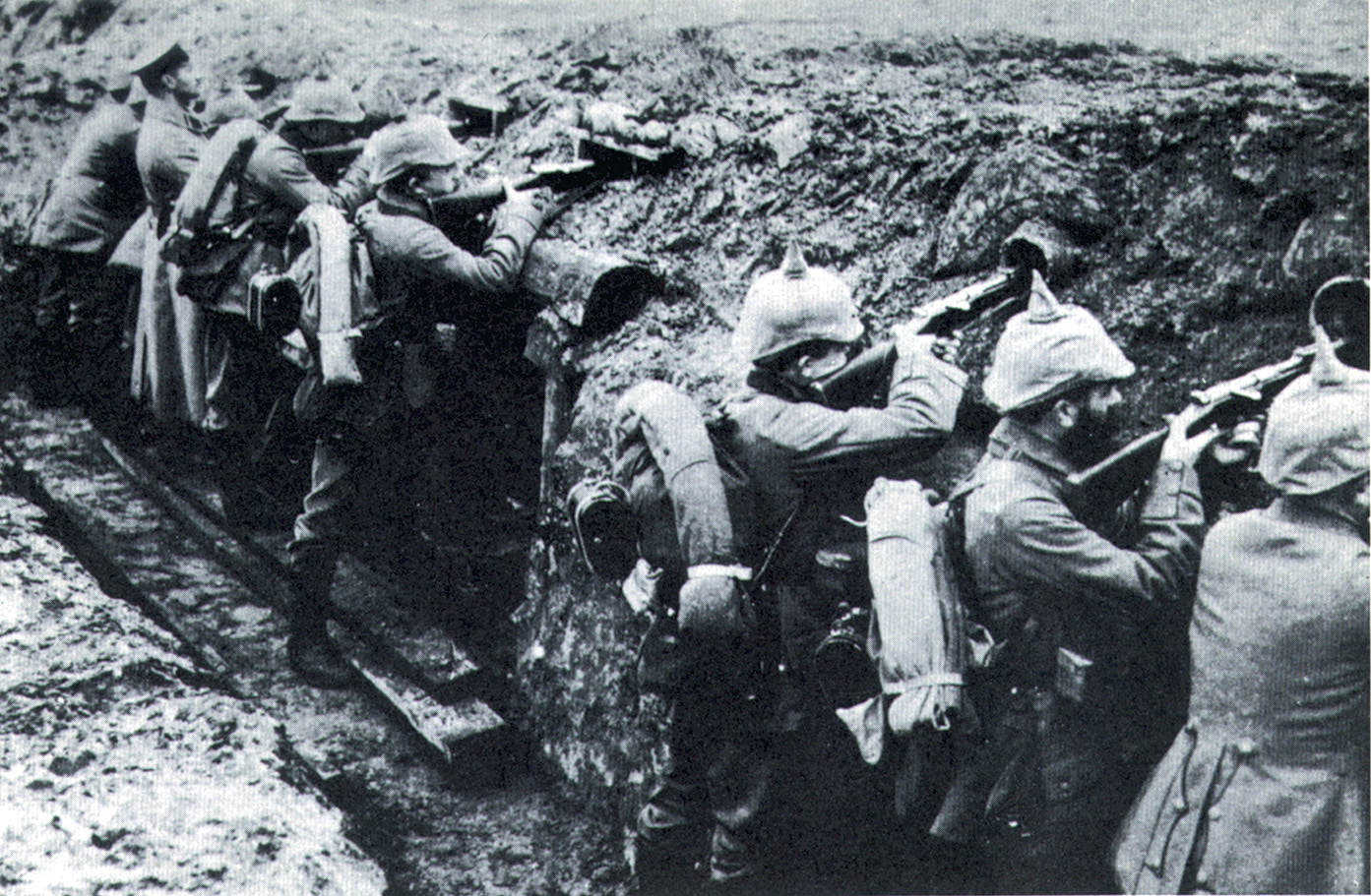 German troops wearing their leather helmets fire through pipes at the French lines early in World War I.