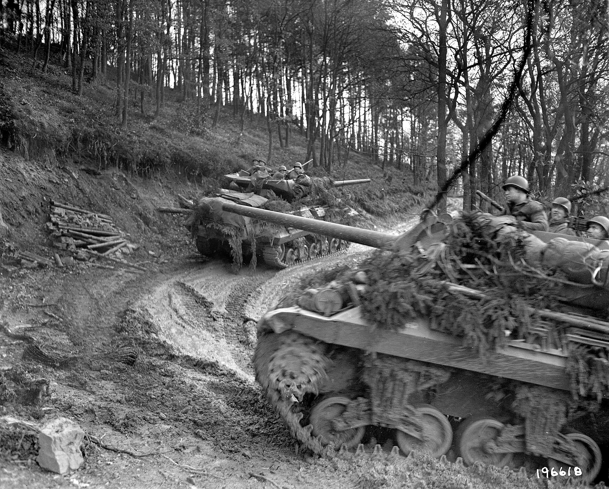 American M-10 tank destroyers crawl up a muddy road through the Hürtgen Forest. The few roads that existed in the rugged, thickly wooded terrain were made nearly impassable by the wet winter weather. 