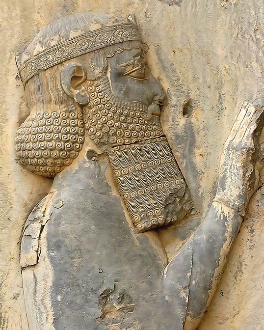 An image of Darius the Great as part of a large rock-relief inscription written in Old Persian, Elamite, and Babylonianon on a cliff at Mount Behistun in Iran.