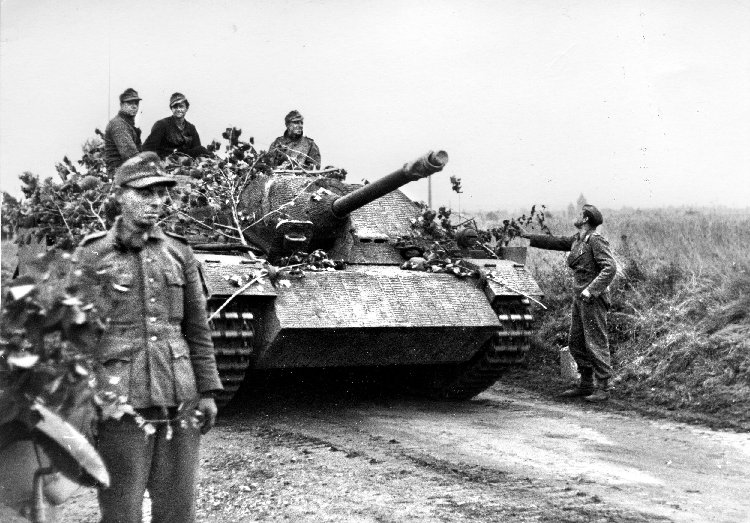 During earlier action in France, members of the 116th Panzer Division add branches to camouflage their Jagdpanzer IV tank destroyer. During Operation Veritable, the division could only muster 22 tanks against the British and Canadian advance.