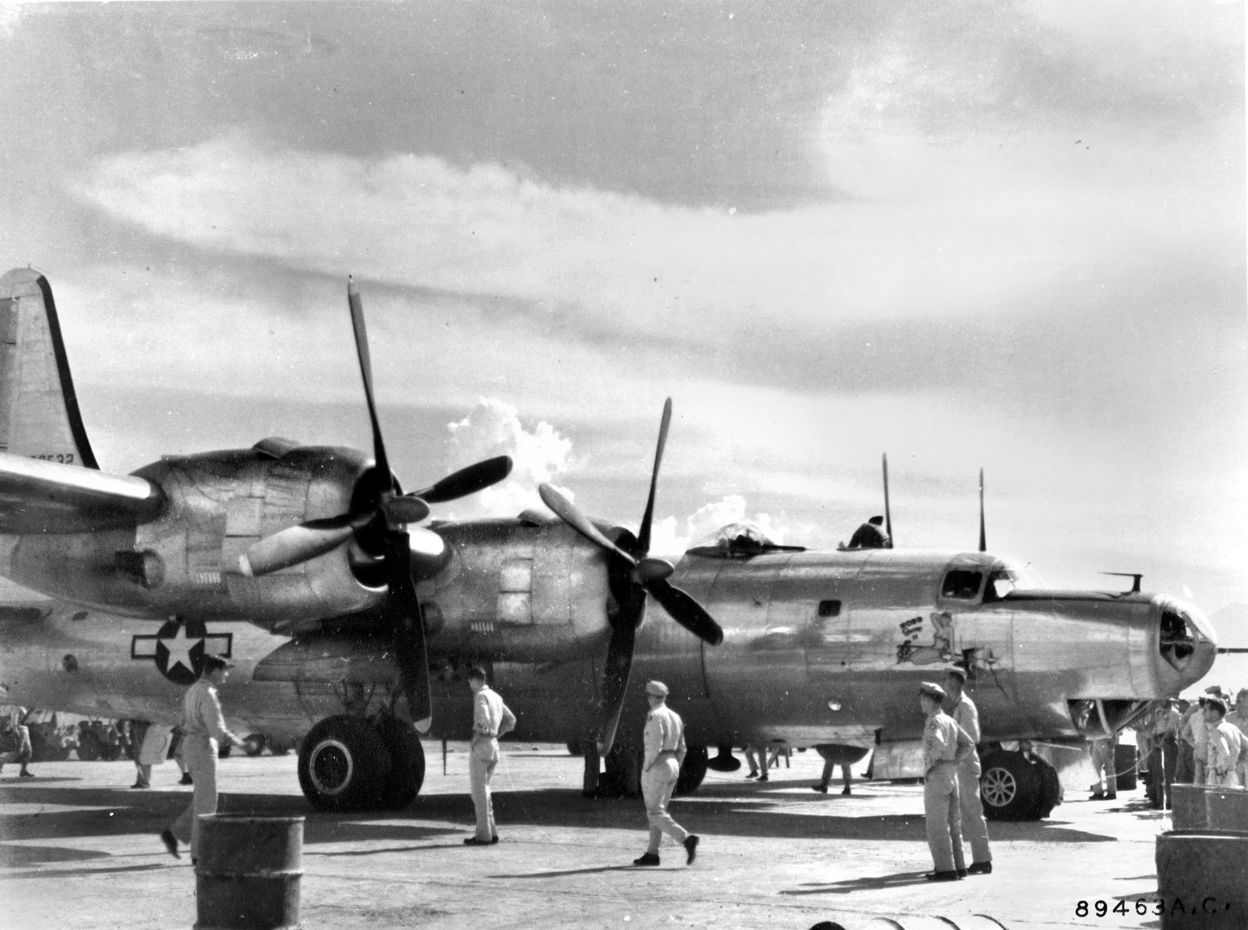 Air crewmen stroll around the Consolidated B-32 Dominator bomber “Hobo Queen II,” the first to arrive in any theater of war. The B-32 project experienced significant delays which, along with the success of the Boeing B-29 Superfortress, nearly spelled the type's demise before it entered production.