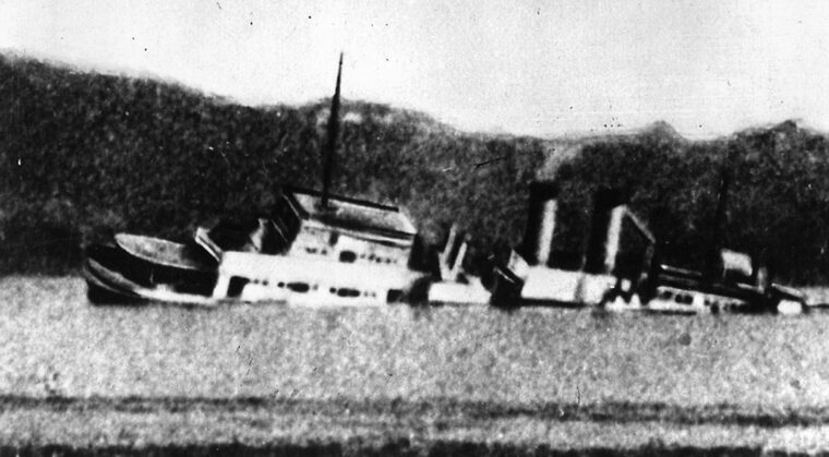 The gunboat USS Panay sinks on the Yangtze River after being hit by Japanese bombers. The Japanese government claimed the incident was a case of mistaken identity even though the vessel was clearly marked as American.