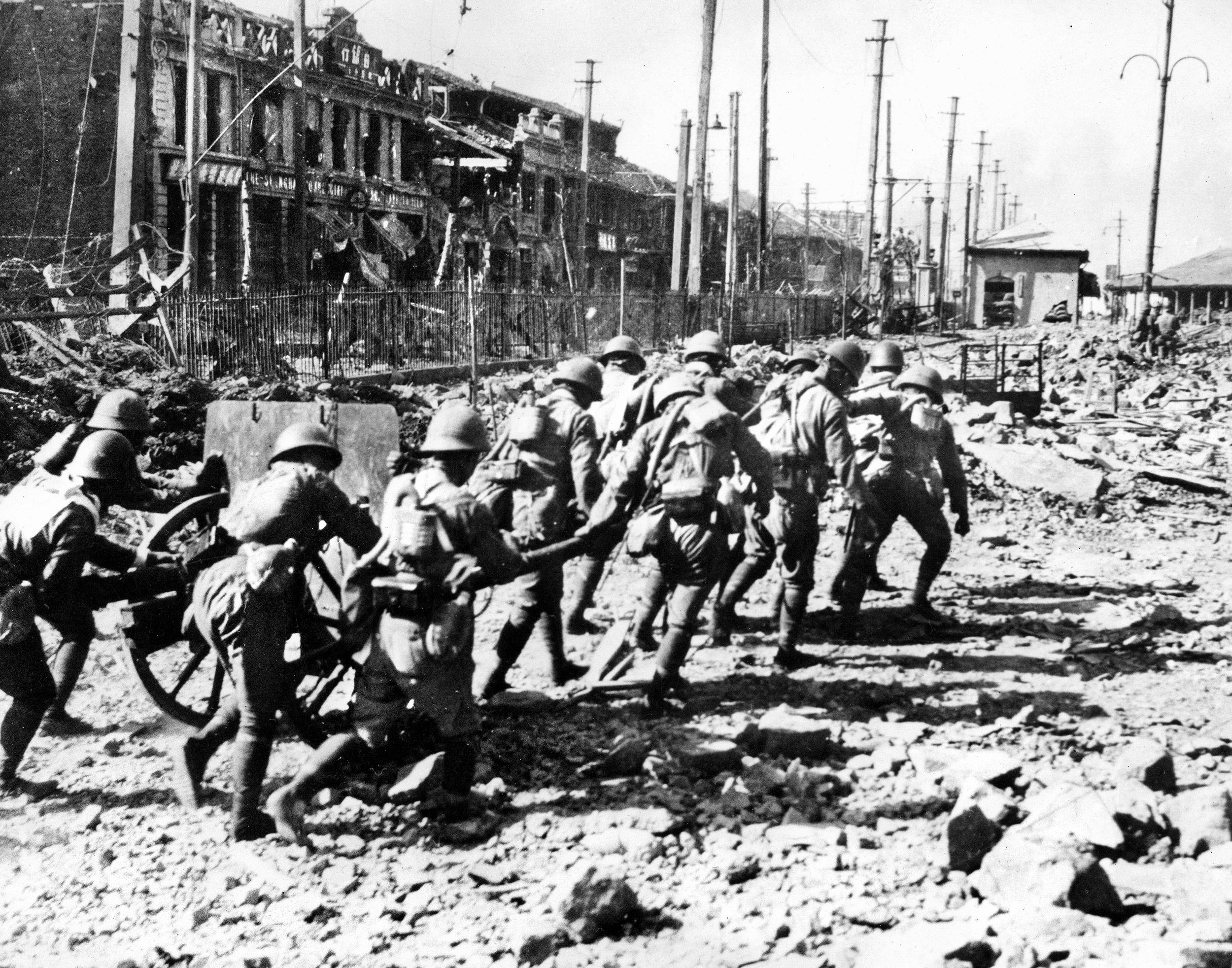 Japanese Marines roll a field gun forward to deal with a pocket of stubborn Chinese resistance that has held up their advance through Shanghai. The Japanese captured a number of major Chinese cities and effectively controlled much of the vast nation’s coastline.