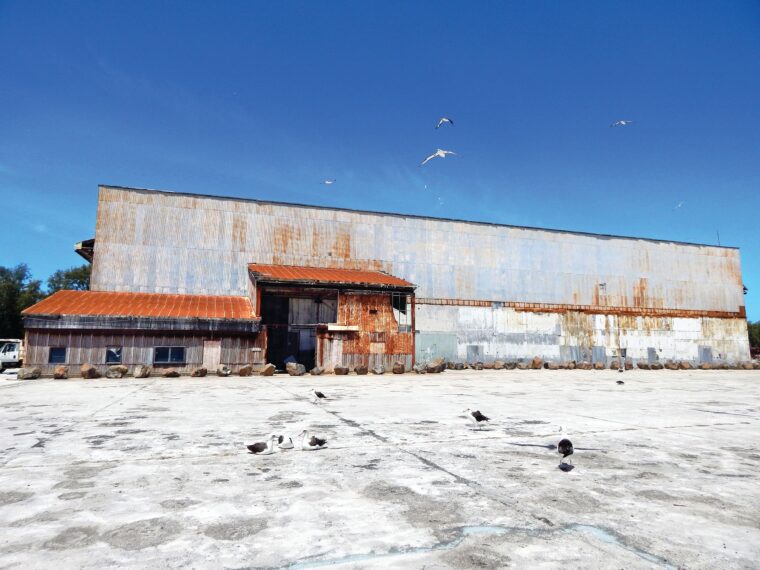 A 2015 photo of the ruins of the seaplane hangar on Midway Atoll. The building was heavily damaged during the bombardment of the atoll on December 7, 1941, when two Japanese destroyers unleashed a torrent of 5-inch shells.