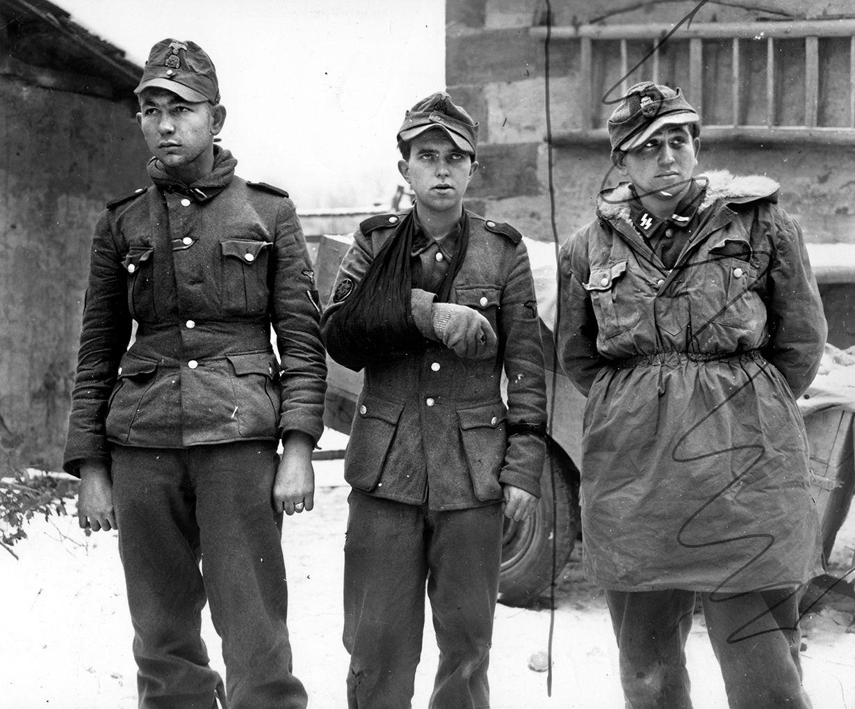 German POWs from the 6th SS Mountain Division captured by the 45th Division. U.S. censor marks indicate a prisoner to be cropped from the photo.