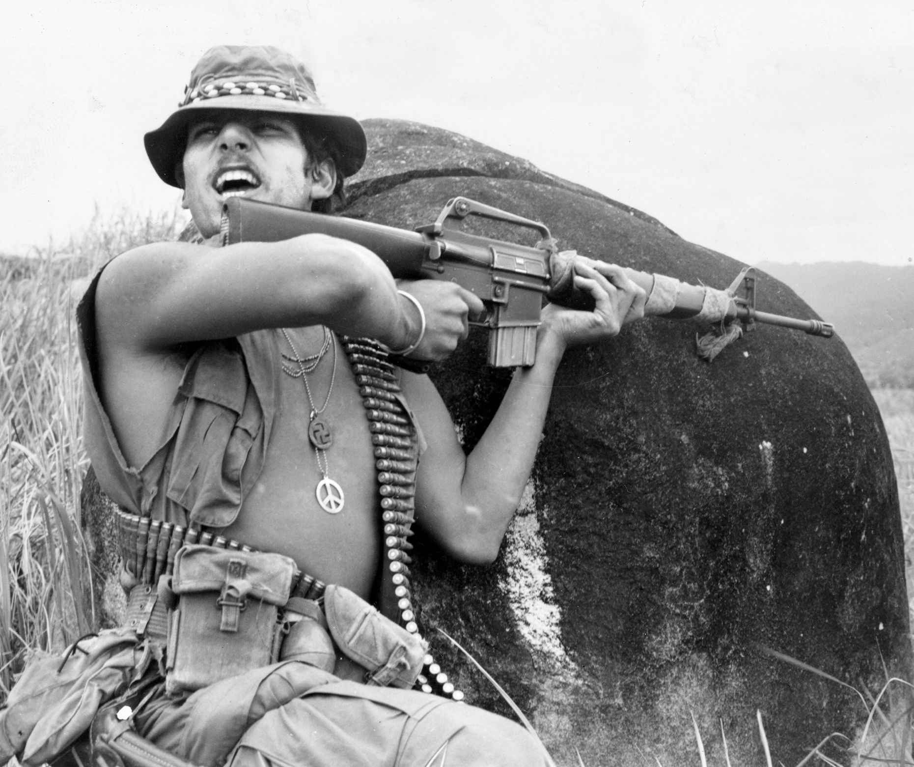 His M-16 at the ready, SP4 Richard Champion, squad leader in the 11th Light Infantry Brigade shouts orders under fire during a patrol southeast of Chu Lai in January 1971.