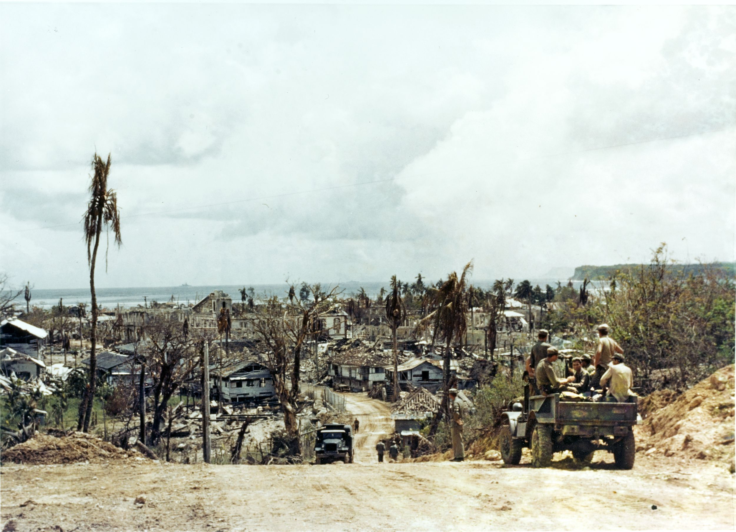 U.S. Marines ride aboard a truck headed into Agana, Guam’s devastated capital, after the island has been secured.