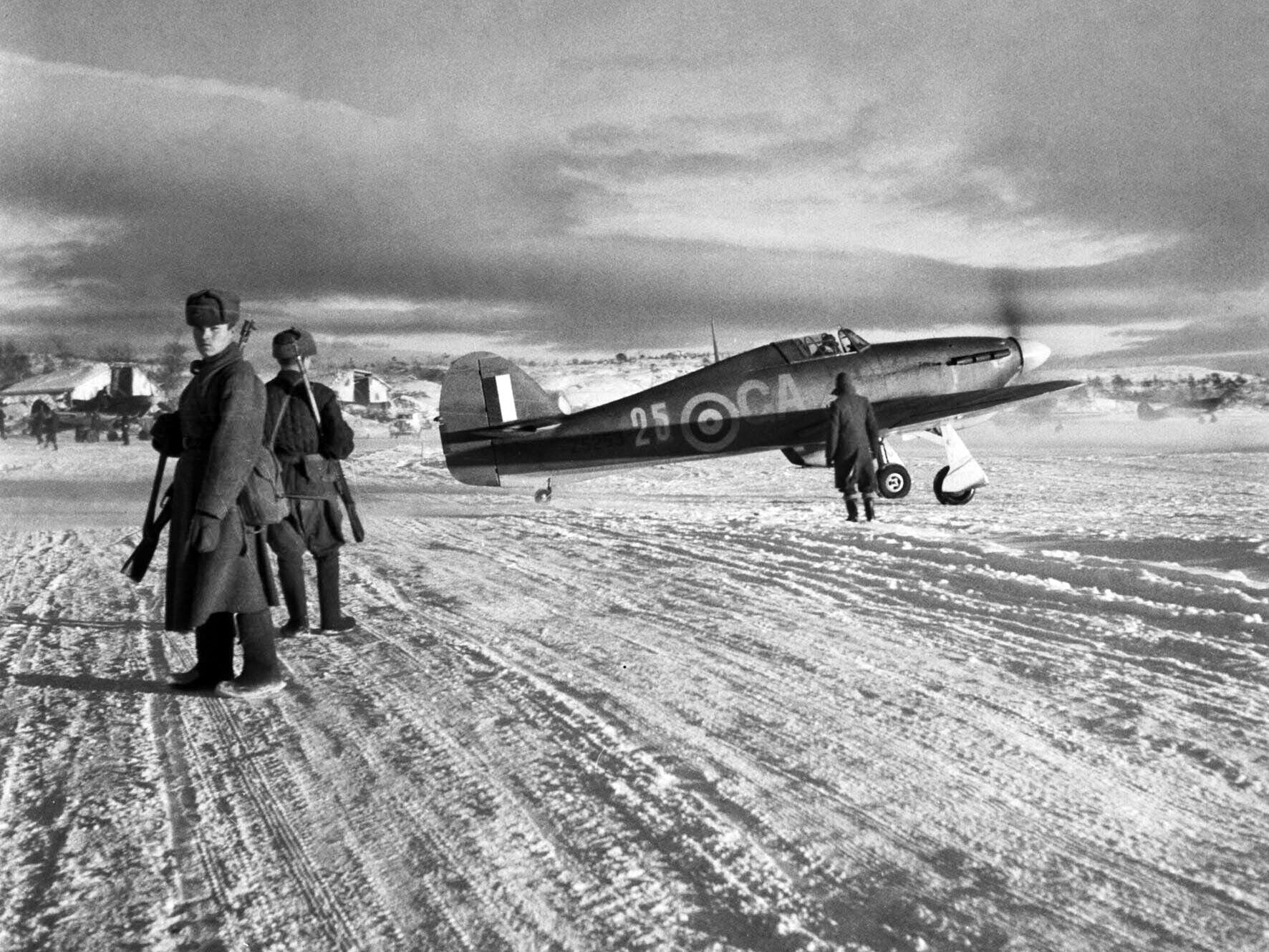 Russian sentries patrol the Vaenga airfield in October 1941 as an RAF Hawker Hurricane fighter prepares to take off. Vaenga was located only 15 miles from the front lines.
