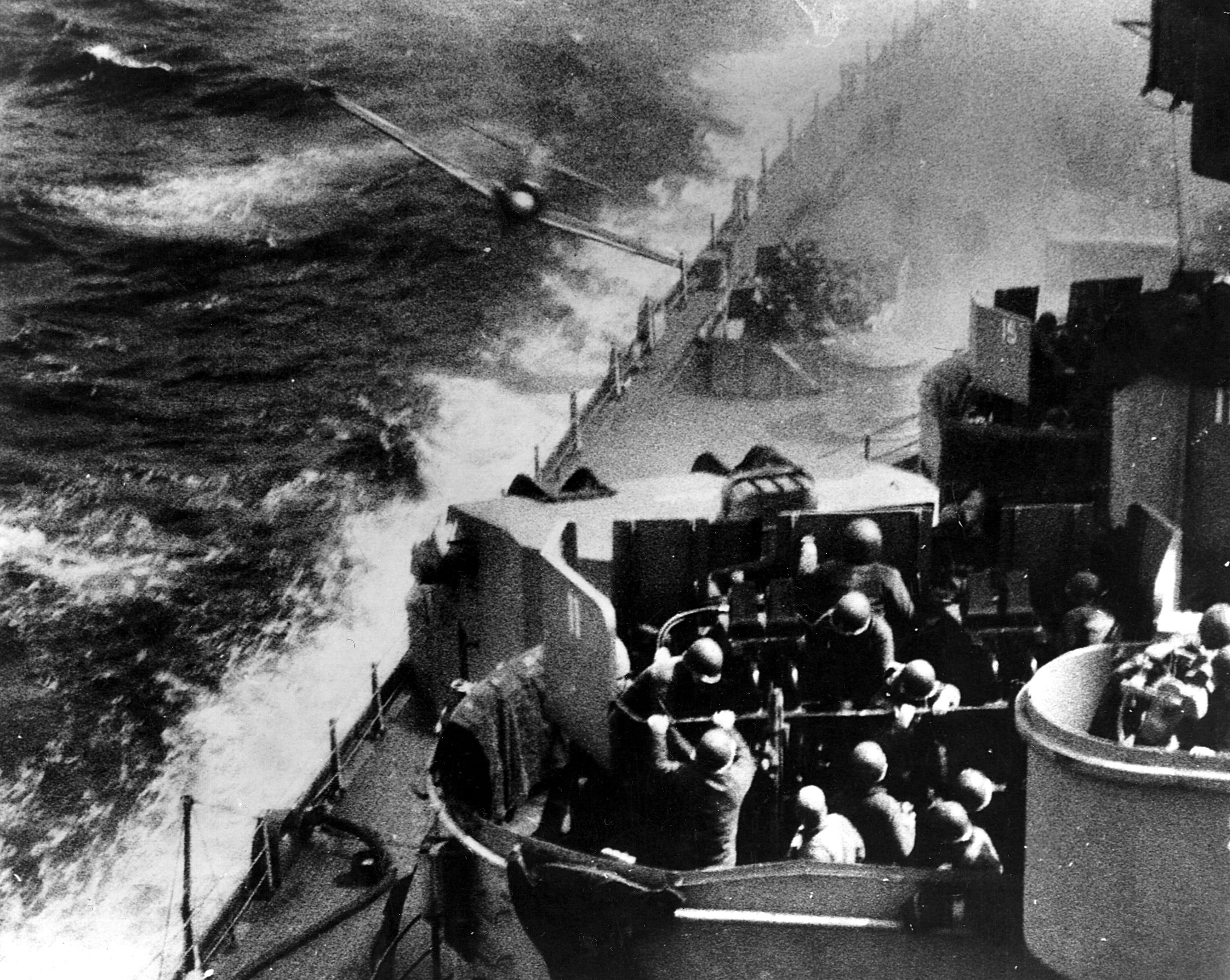 A Japanese kamikaze swerves low over the whitecaps just moments before impact with the USS Missouri in the waters off Okinawa.