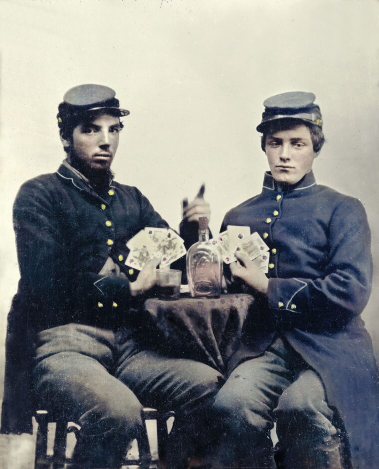 Unidentified Union soldiers pose for the camera with whiskey and playing cards.