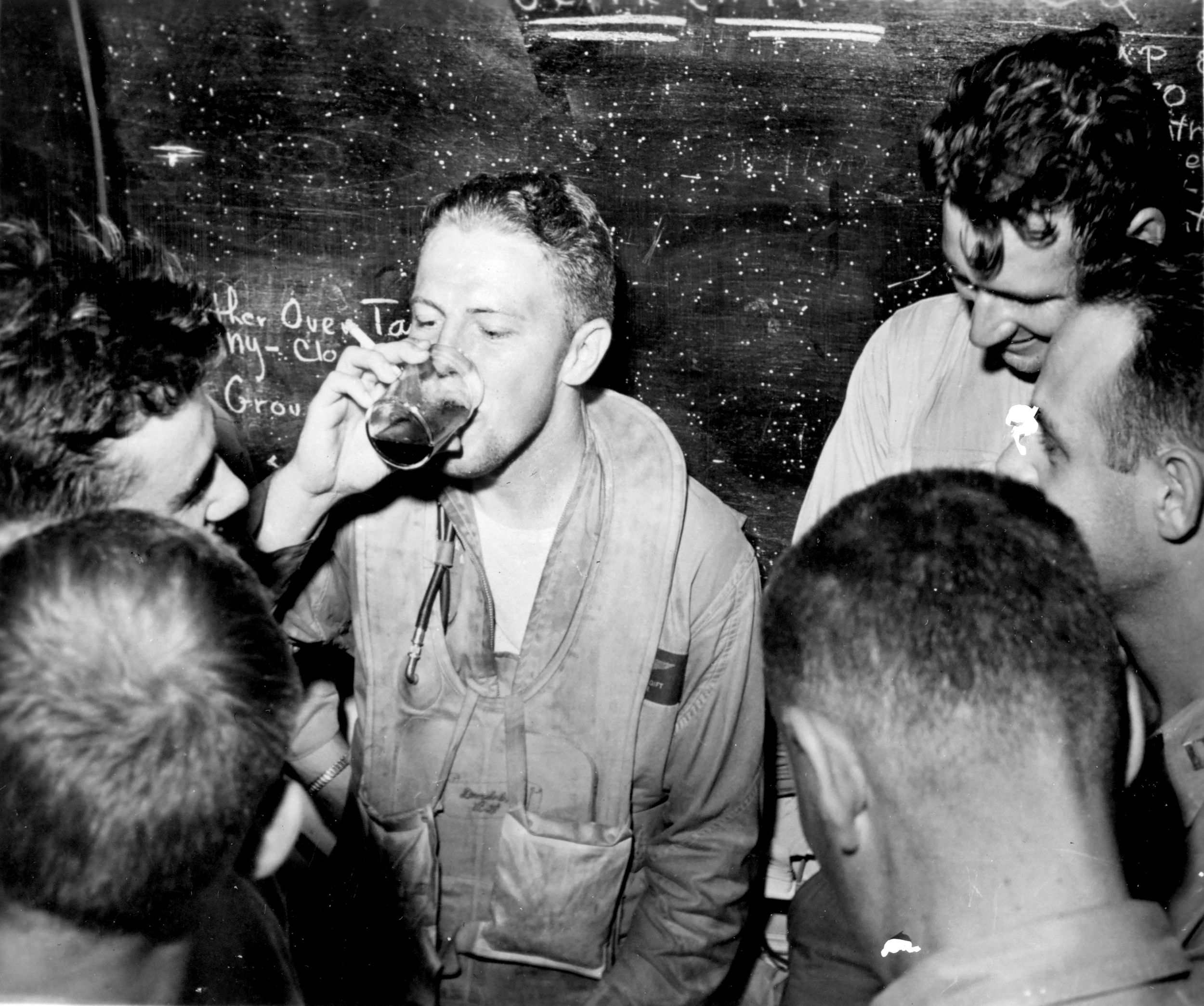 Lieutenant Ronald P. “Rip” Gift relaxes with other pilots in a ready room on board USS Monterey (CVL-26), after landing on her at night following strikes on the Japanese fleet, June 20, 1944.