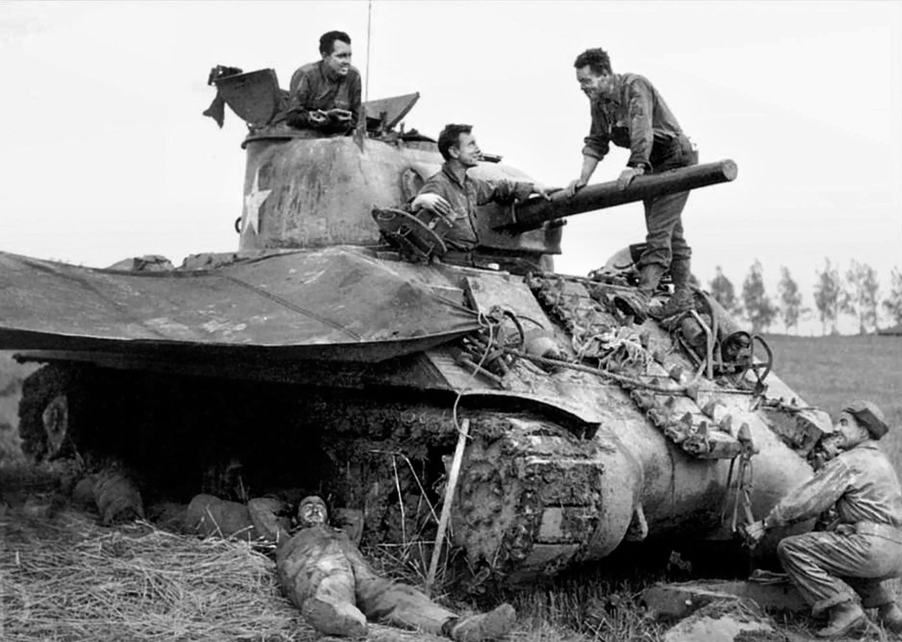 The crew of a 4th Armored Division Sherman tank takes a break near Arracourt in Lorraine, France, in September 1944. The hard-charging division, which had liberated the cities Nantes, Orleans, Loire, St. Calais, Sens and Troyes, as well as countless villages, was finally slowed only by a lack of fuel.