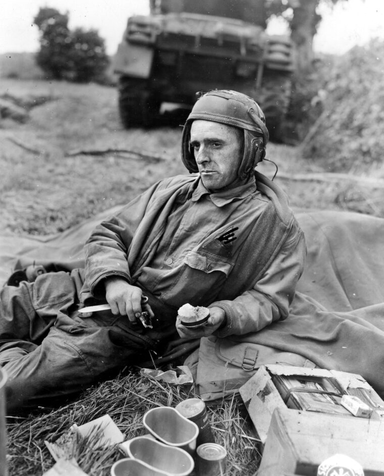 Tank co-driver Private Jerry Coleman of the 3rd Armored Division eats his “K” rations somewhere in France in 1944.